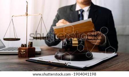 Business and lawyers discussing contract papers with brass scale on desk in office. Law, legal services, advice, justice and law concept