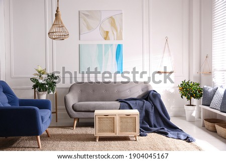 Beautiful living room interior with comfortable gray sofa Royalty-Free Stock Photo #1904045167