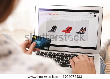 Woman with credit card using laptop for online shopping indoors, closeup Royalty-Free Stock Photo #1904079583
