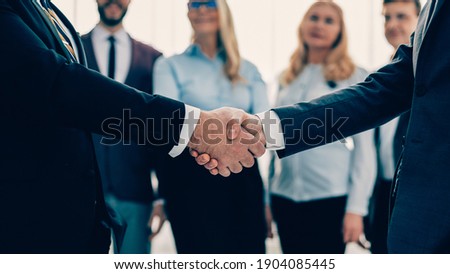 close up. business people shaking hands with each other. Royalty-Free Stock Photo #1904085445