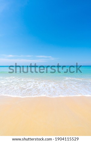 Beach and sea. Sand on sea water clear. Blue sea blue sky background. Vertical Photo Concept.