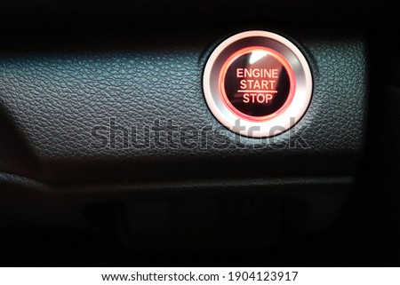 Red push engine start and stop Button on car. New technology of car. transportation and sefety concept.
