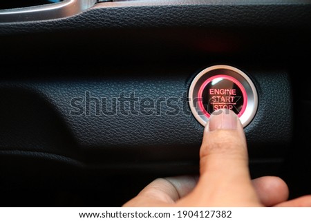 Finger touching car engine start button on car icon of car background. New technology of car. transportation and sefety concept.