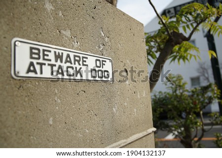 Dog caution sign on the wall of the building                               