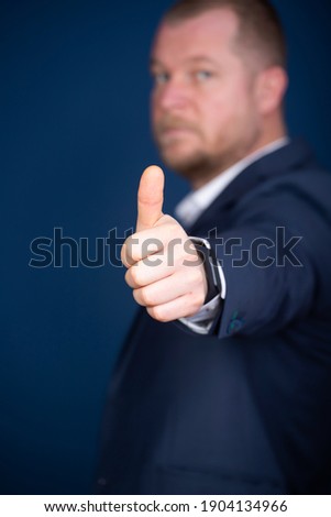 Businessman showing OK sign or thumb up. Excellence of the business or service concept.