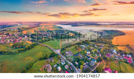 Aerial landscape photography Stunning dawn on Ukrainian countryside with foggy fields. Attractive summer sunrise on outskirts of Ternopil town, Ukraine, Europe. Traveling concept background.