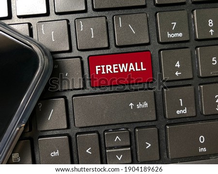 Red button on keyboard written FIREWALL. Technology, security and business concept.