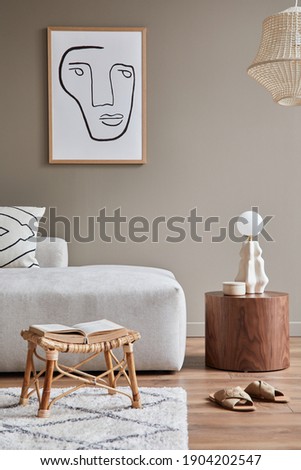 Interior design of cozy living room with stylish sofa, coffee table, dired flowers in vase, mock up poster, carpet, decoration, pillows, plaid and personal accessories in modern home decor. Template.