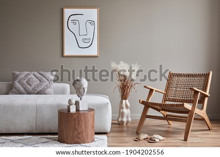 Modern concept of living room interior with design modular sofa, rattan armchair, dried flowers in vase, coffee table, decoration and elegant personal accessories in stylish home decor. Template.