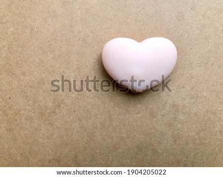 Soft pink heart in Valentine day. Valentine’s Day background with pink heart on plywood. Holidays greeting card space.