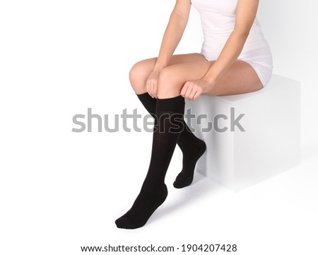 Compression Hosiery. Medical Compression stockings and tights for varicose veins and venouse therapy. Socks for man and women. Clinical compression knits. Comfort maternity tights for pregnant women. Royalty-Free Stock Photo #1904207428