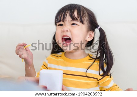Angry asian kid.Little asian girl looking at her mother and fighting with her mom.Furious hungry toddler kid got upset and sad.Stubborn child bad attitude.Depressed little girl complaining with mom. Royalty-Free Stock Photo #1904208592