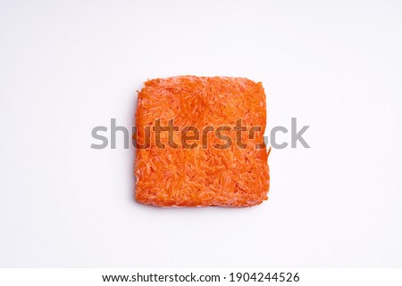Orange bricks of frozen grated carrots. Procurement of frozen food. Semifinished. Royalty-Free Stock Photo #1904244526