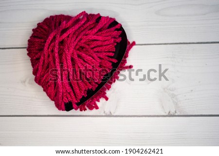 Close up of a broken heart on wood background. Break heart background. Past love concept. Anti-Valentine's day card. Top view. Space for text. 