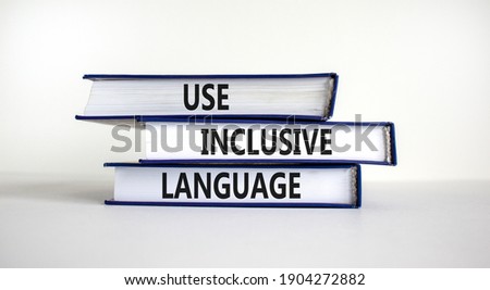 Use inclusive language symbol. Books with words 'Use inclusive language' on beautiful white table, white background. Business and use inclusive language concept. Copy space.