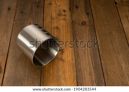 Empty Metal Mug on Wood Table. Copy Space.