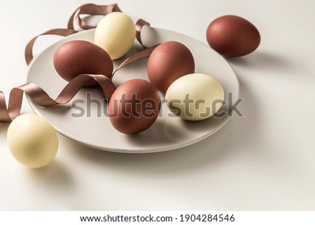 Happy Easter, straight colored eggs on a light background. Copy space.