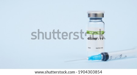 Vaccine against coronavirus, covid-19 concept. on a blue background. copy space, banner