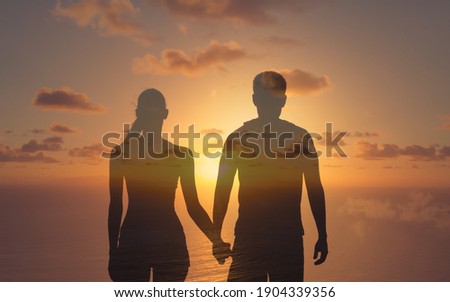 Silhouette of man and woman in love holding hands. People relationships and valentines day concept.  