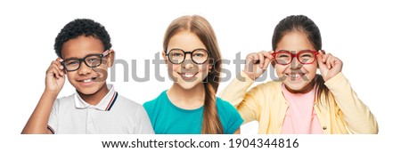 Group of smiling multiethnic kids wearing modern eyeglasses on white background. Children's vision corrective concept Royalty-Free Stock Photo #1904344816