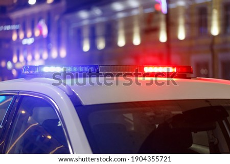 night police car lights in city with selective focus and bokeh blur