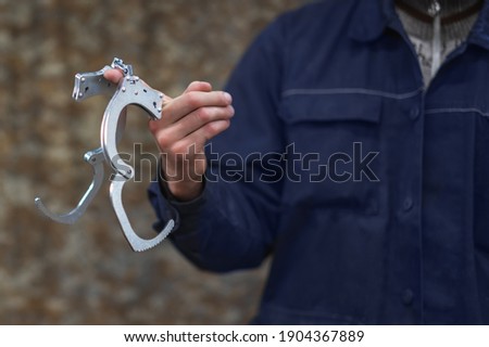 The locksmith has handcuffs on his finger. Production of special equipment