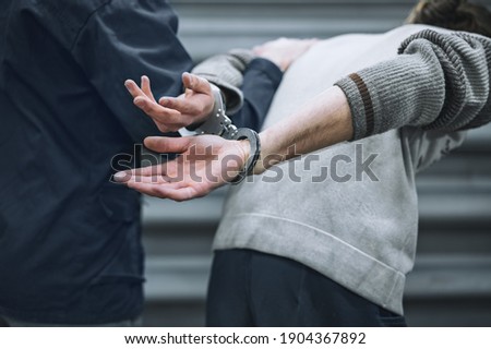 the prisoner is handcuffed. Make an arrest. Preventive measures in the form of detention. The convoy Royalty-Free Stock Photo #1904367892