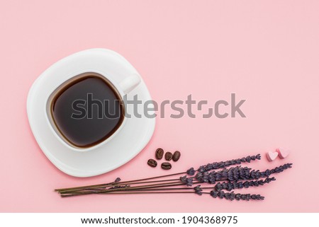 dry Lavender bouquet with a cup of coffee on pink background. Morning mood concept