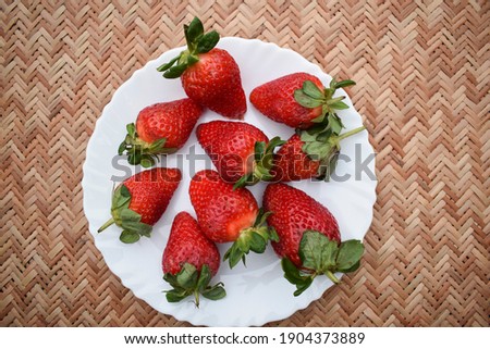Fresh bright red strawberries with fresh leaves harvested in India. Indian organic strawberry fruit