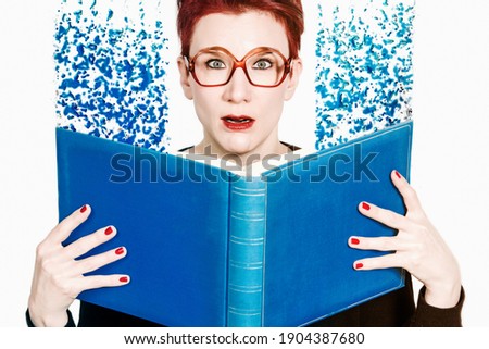 red-haired woman with glasses reading in a blue book with liquify effect