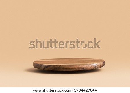 Round wooden podium for food, products or cosmetics against bright brown background. Royalty-Free Stock Photo #1904427844