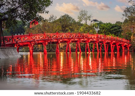 Hanoi Red Bridge at night. The wooden red-painted bridge over the Hoan Kiem Lake connects the shore and the Jade Island on which Ngoc Son Temple stands Royalty-Free Stock Photo #1904433682