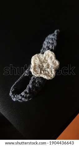 bracelet made in crocheting with simple white flower