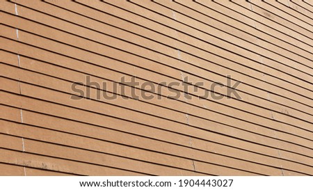 Artificial wood wall in brown oblique line. Vintage house wall in bottom view, background and texture for design. Selective focus