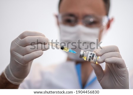 The doctor dials the coronavirus vaccine into a syringe. Vaccination against covid-19. Development of a coronavirus vaccine. 