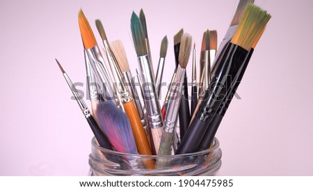 Multiple Painting Brushes Set for Watercolor or Acrylic Paints Standing in a Glass Jar