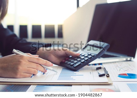 Close-up calculator  to calculate the company's financial results On the wooden table in the office and business work background, tax, accounting, statistics, and analytical research concept Royalty-Free Stock Photo #1904482867