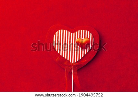 red striped heart shape decoration on textile background