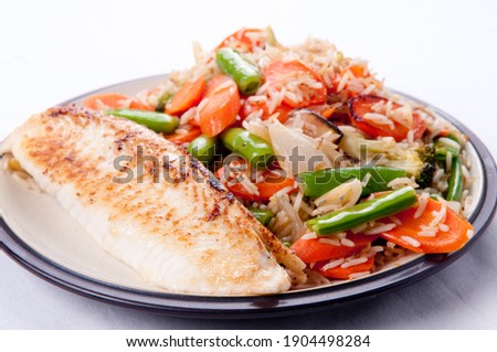 pan seared tilapia fish filet and rice stir fry