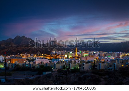 Illuminated buildings during an evening in Muscat, Oman with beautiful sky in the background Royalty-Free Stock Photo #1904510035