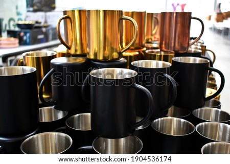 The beautiful brass cups were on sale at the market .