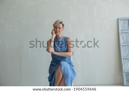 mid adult woman posing emotion in studio Royalty-Free Stock Photo #1904559646