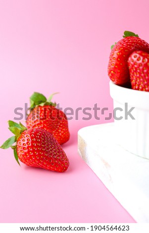 selective focus on image of fresh strawberry on the pink background 