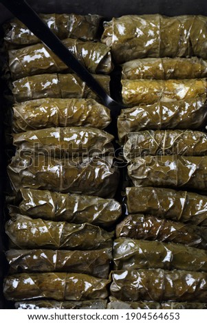 Traditional Oriental dolmades - stuffed grape leaves baked in ceramic form