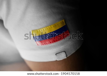 Patch of the national flag of the Venezuela on a white t-shirt
