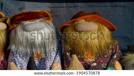 Texture, background, pattern, folk art, funny Russian men with beards and mustaches. Toy doll