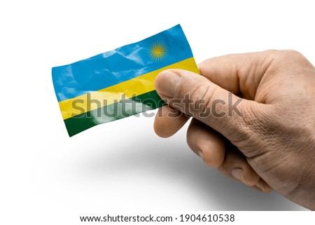 Hand holding a card with a national flag the Rwanda