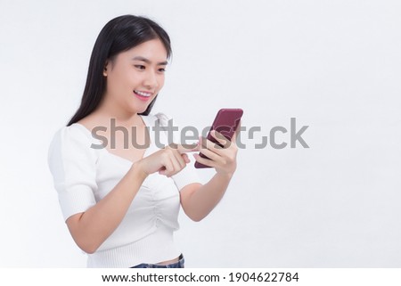 Portrait of beautiful asian women Use the mobile phone happily on a white background