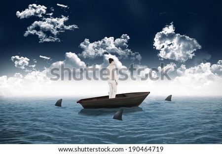 Composite image of asian businesswoman against sharks circling small boat in the sea