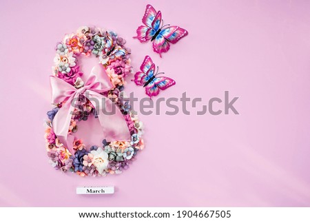 International Women's Day. Banner, flyer, beautiful postcard for March 8. Flowers and butterflies in the shape of the number 8 on a pink background. Royalty-Free Stock Photo #1904667505